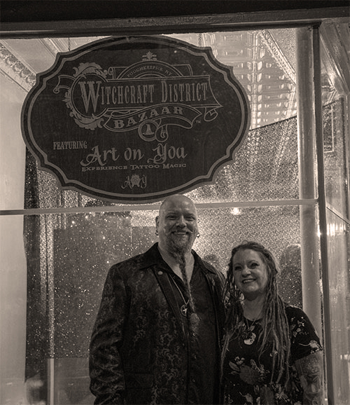 Priestess Renee & Reverend Storm Anderson in front of Witchcraft District Bazaar where Art on You is featured inside